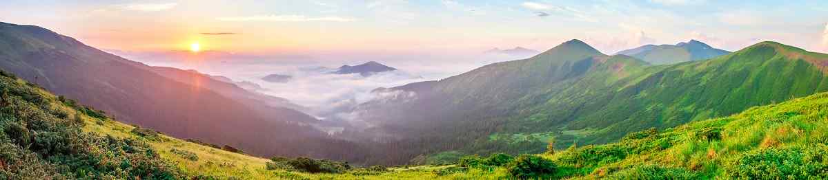 Beautiful sunrise in mountains with white fog below panorama shutterstock 1011673036
