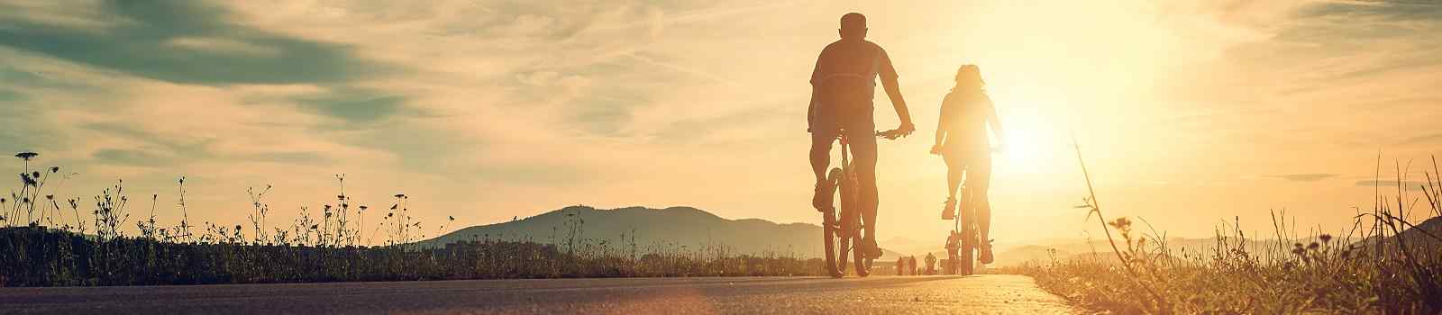 FUGGER-AUG-INNS  Cyclists are on the sunset road  shutterstock 498444379