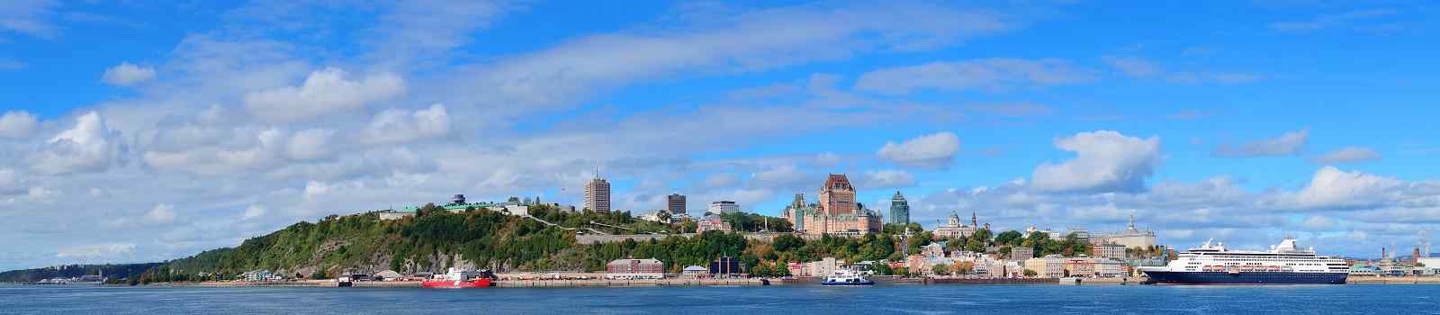 ROUTE-VOYAGEURS Quebec City skyline panorama over river with blue sky and cloud shutterstock 176713067