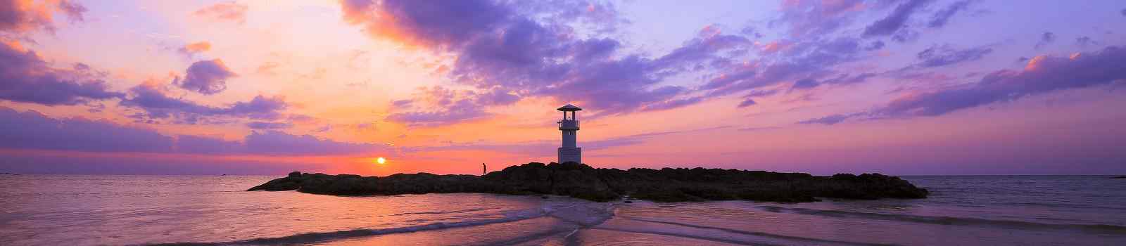  Lighthouse searchlight beam near ocean at sunset shutterstock 463686620