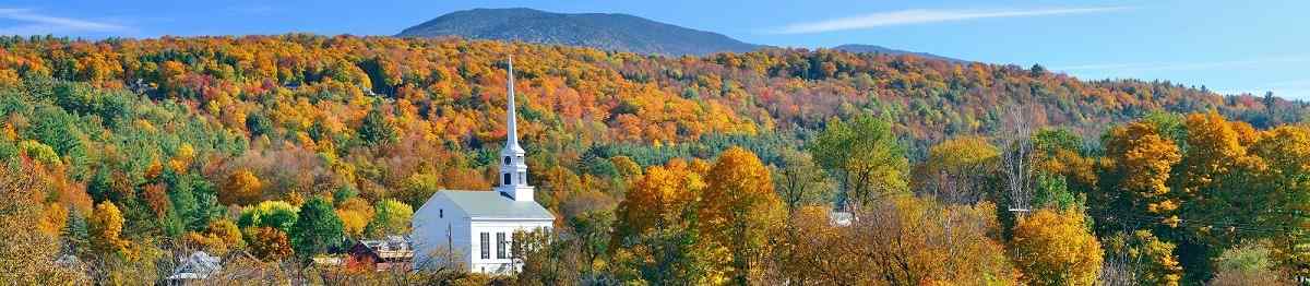 Stowe panorama in Autumn with colorful foliage and community church in Vermont 510816685