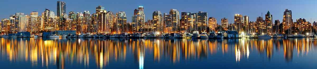 Vancouver downtown architecture and boat with water reflections at dusk panorama 386316580